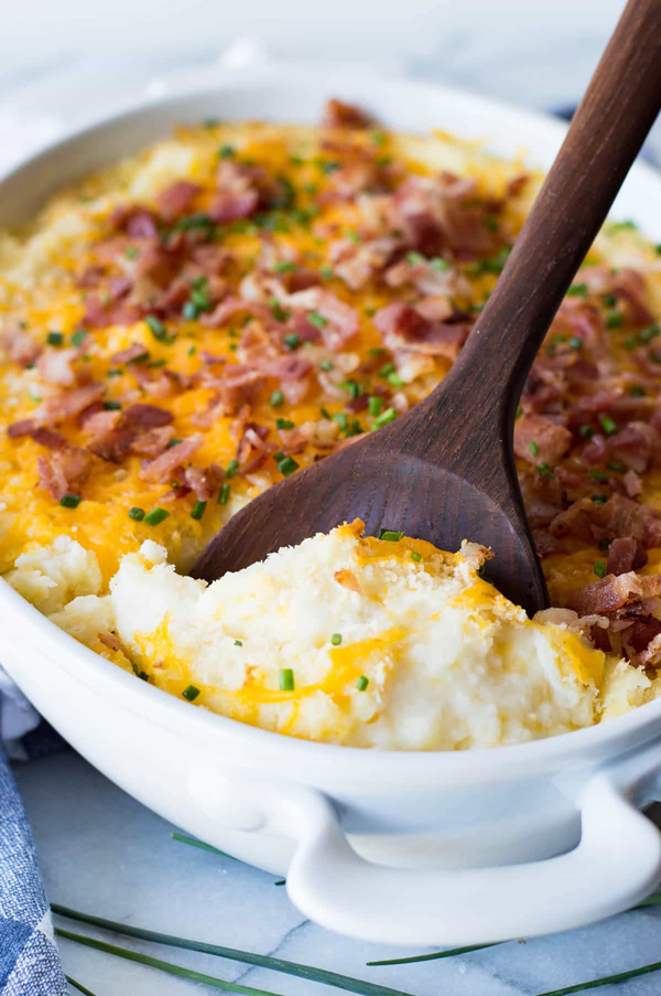 Mashed potato casserole with cheese, herbs, and bacon top