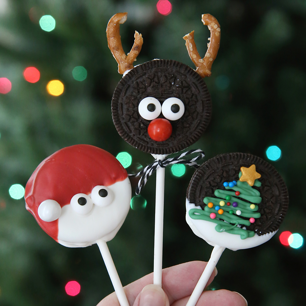 Christmas oreo pops decorated to look like Rudolph, Santa and christmas tree