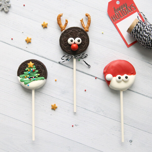 Christmas oreo pops decorated to look like Rudolph, Santa and christmas tree