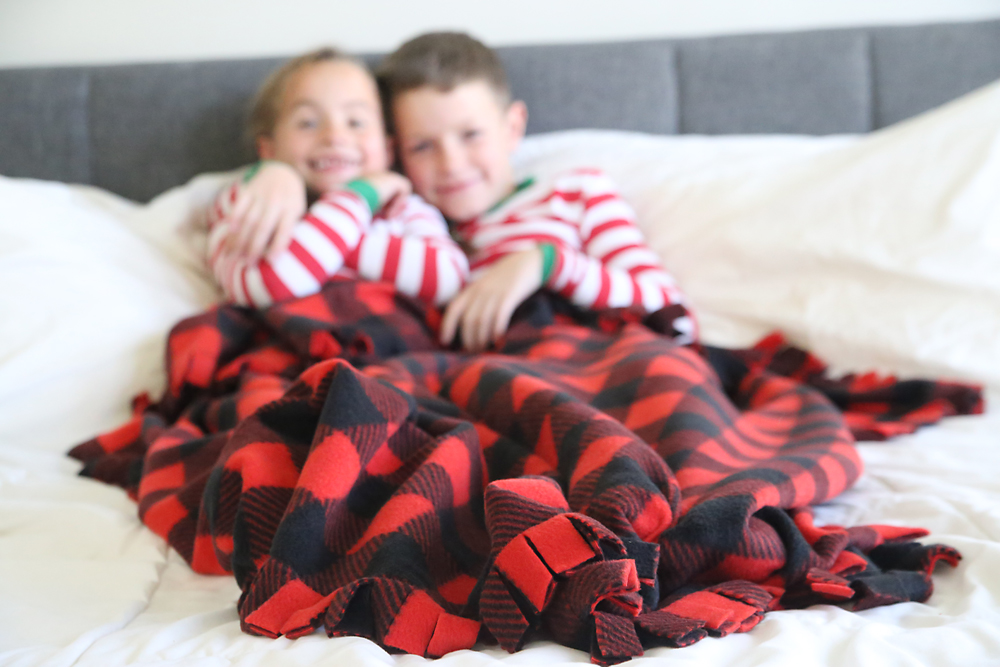 Brother and sister with a DIY fringed fleece blanket