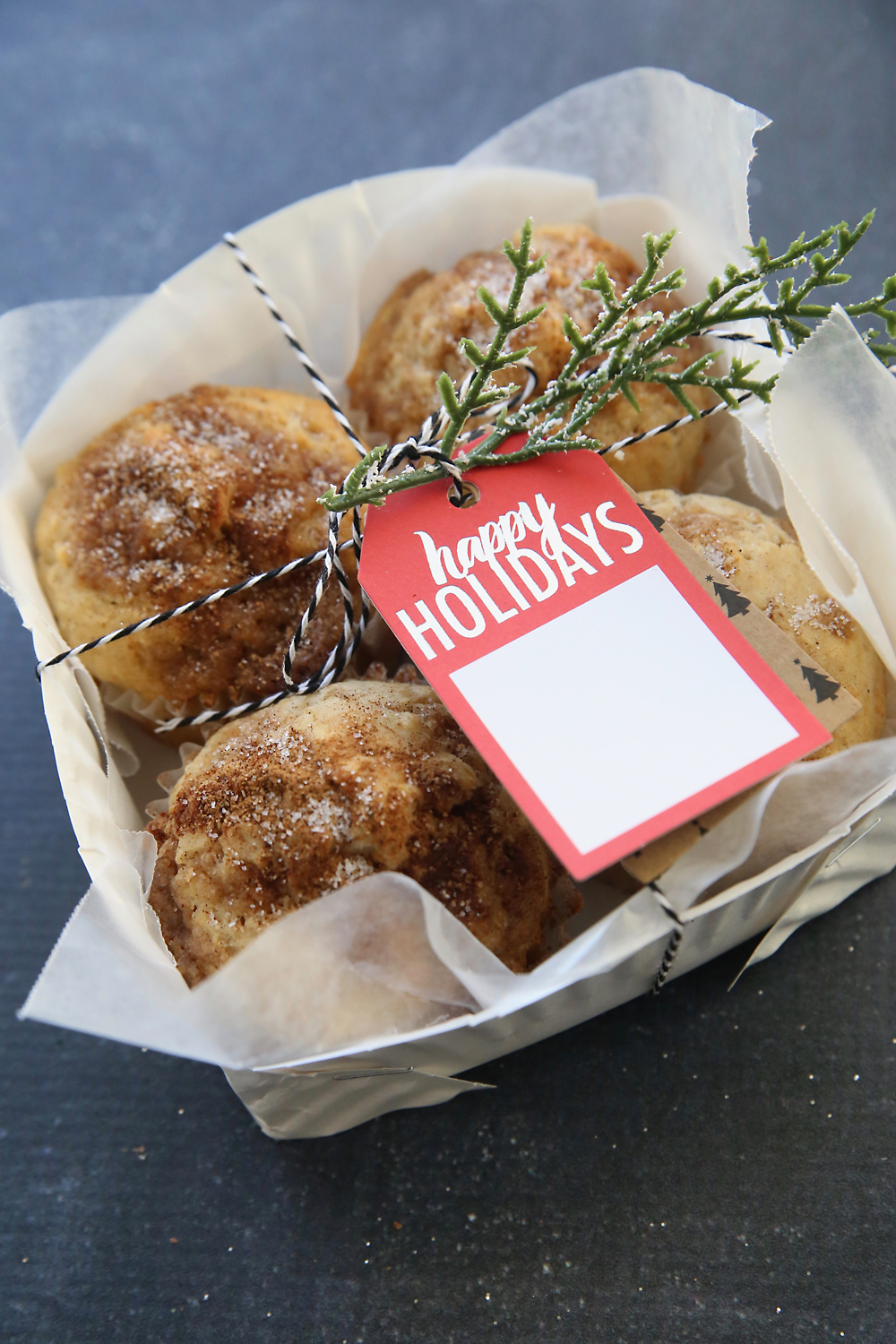 Paper plate basket filled with muffins with holiday tag