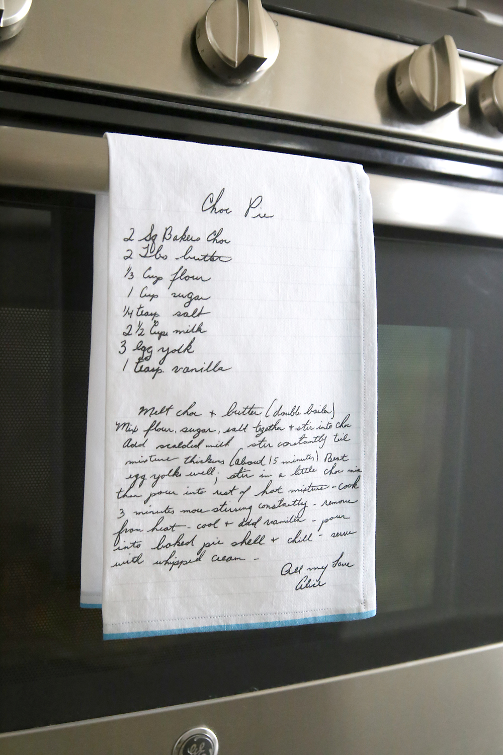 Recipe kitchen towel hanging on an oven door