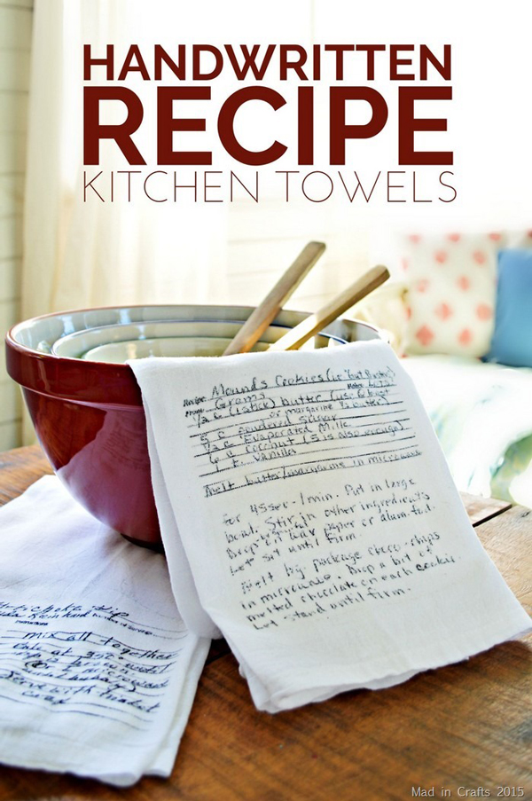 Kitchen towel with handwritten recipe on it, lying on a stack of kitchen bowls and wood spoons