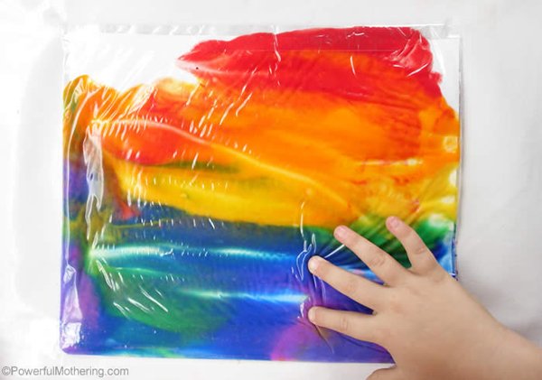 Paper and paints inside a large ziplock bag