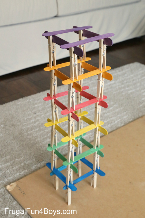 Kid activity tower built from popsicle sticks and clothespins