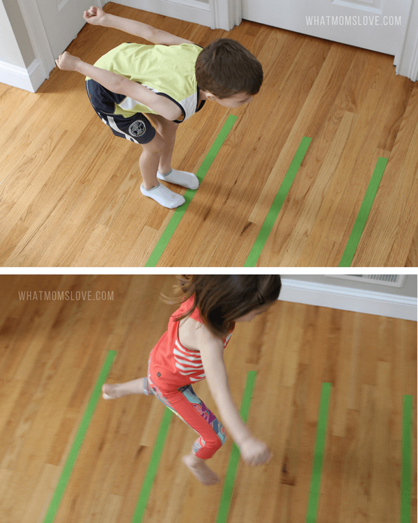 Kids jumping across lines that have been made on the floor with masking tape