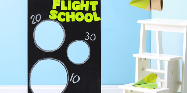 Board with circles cut out of it to send paper airplanes through