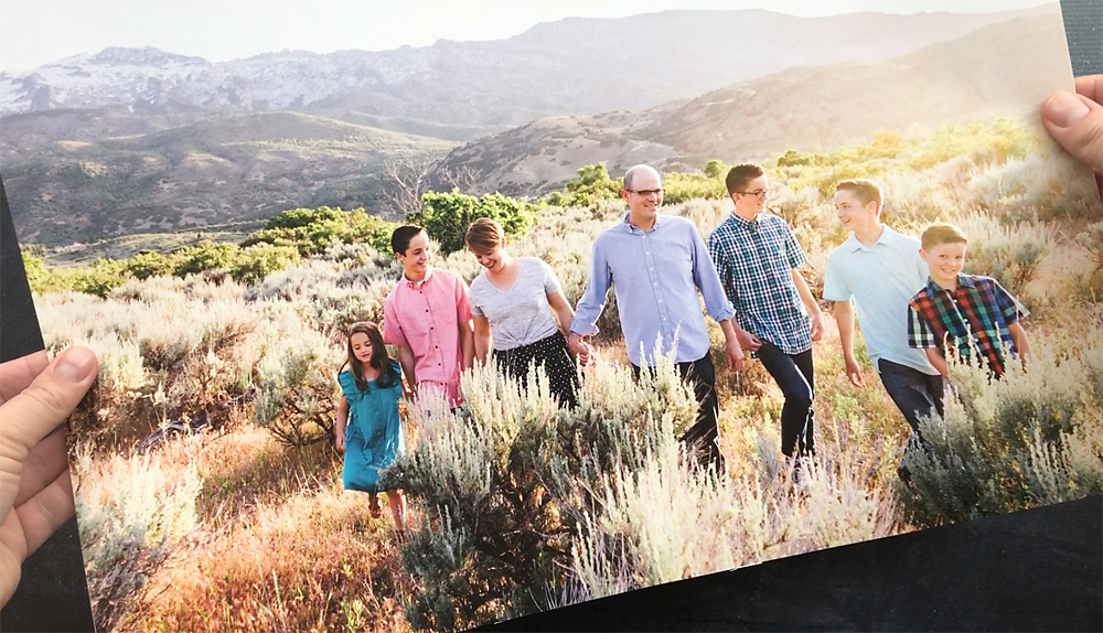A family photo with people in front of a mountain