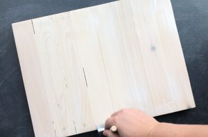 Painting mod podge on the wood pallet sign