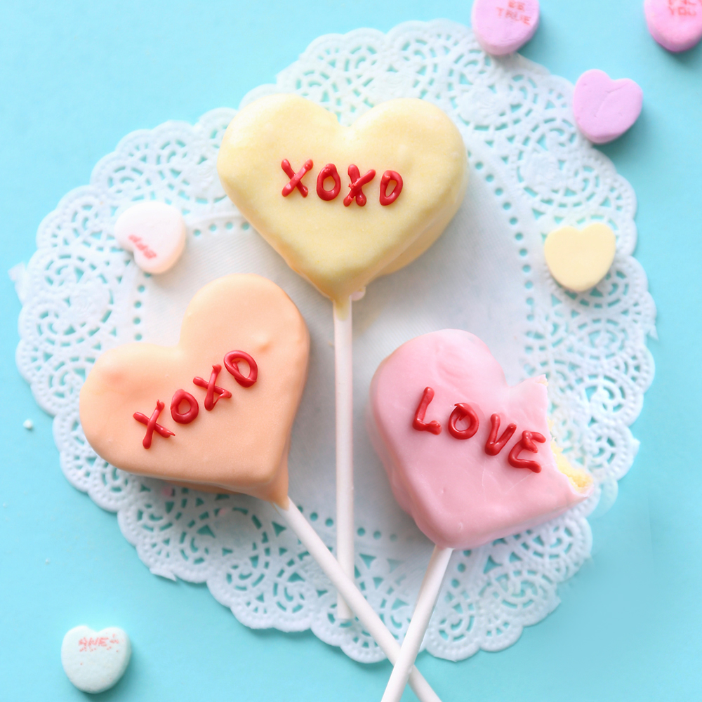 Cake pops decorated to look like conversation hearts