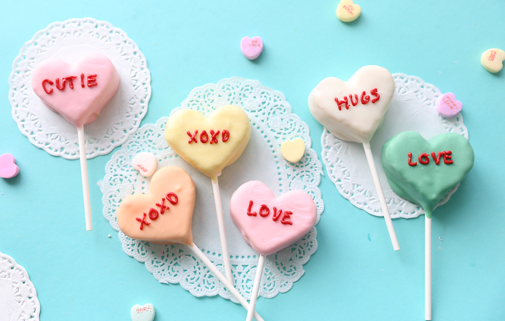 Cake pops decorated to look like conversation hearts