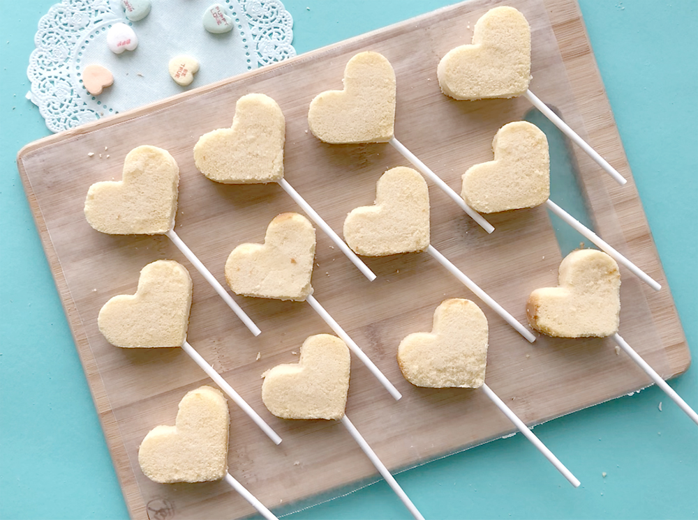 Heart shaped pound cake cutouts with popsicle sticks in them