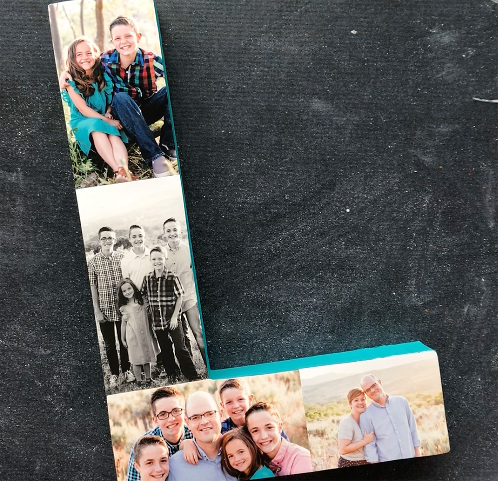 Photos glued down on the paper mache letter