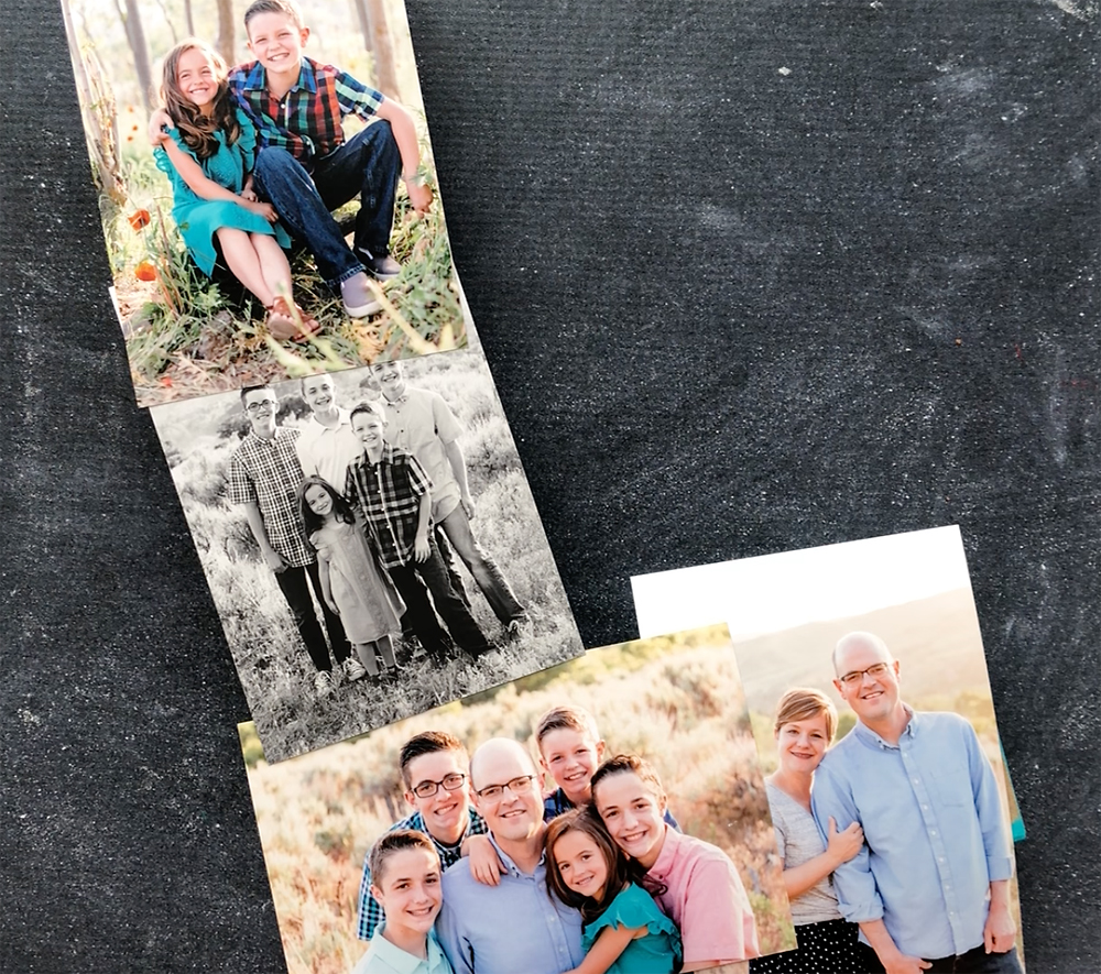 Photos laid out over a large paper mache letter