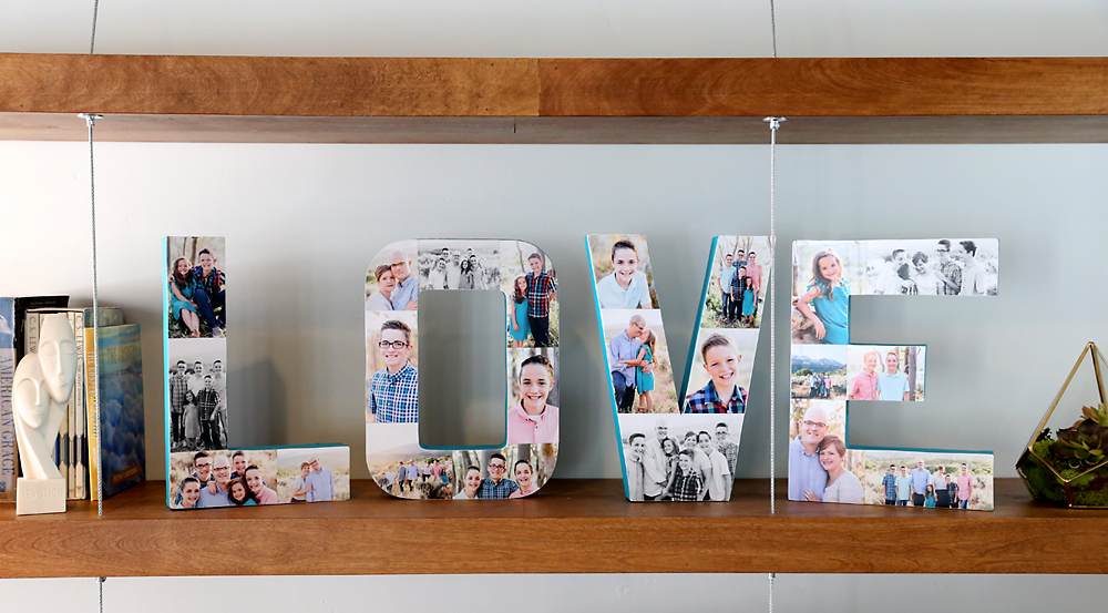 Paper mache letters that spell the word LOVE covered in photos on a shelf