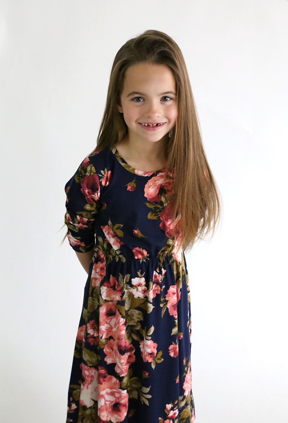 A girl wearing a midi length floral dress made from a sewing tutorial