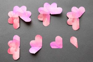 paper rose petals cut along the lines into 7 different size pieces