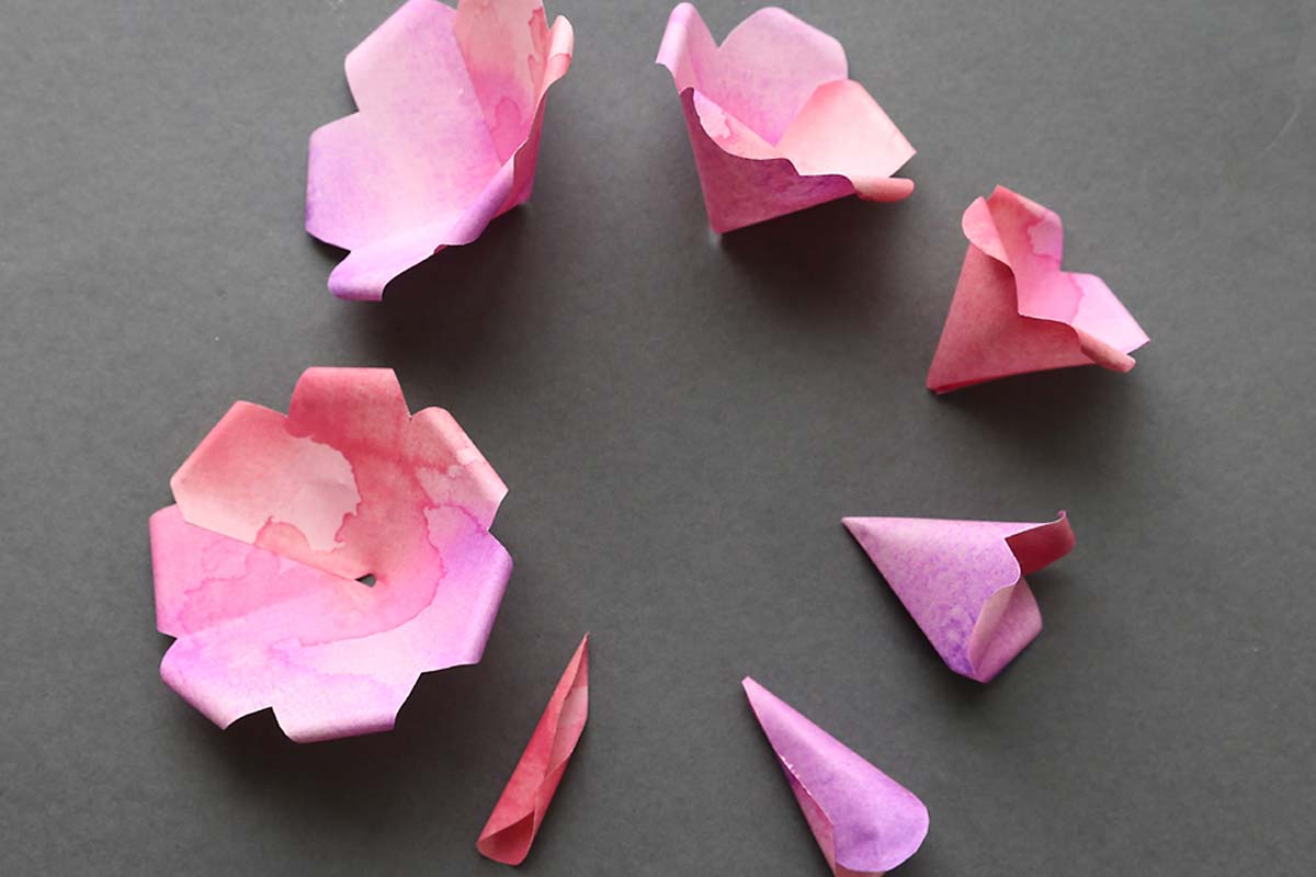 All seven paper petals glued together with edges curled down.