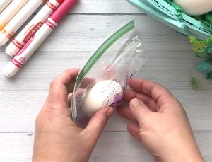 Wrapping the egg in the plastic bag