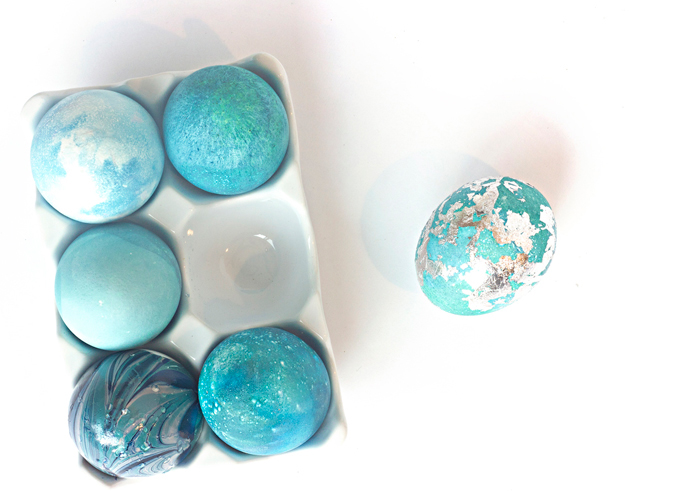 Turquoise colored Easter eggs decorated with silver gold leaf