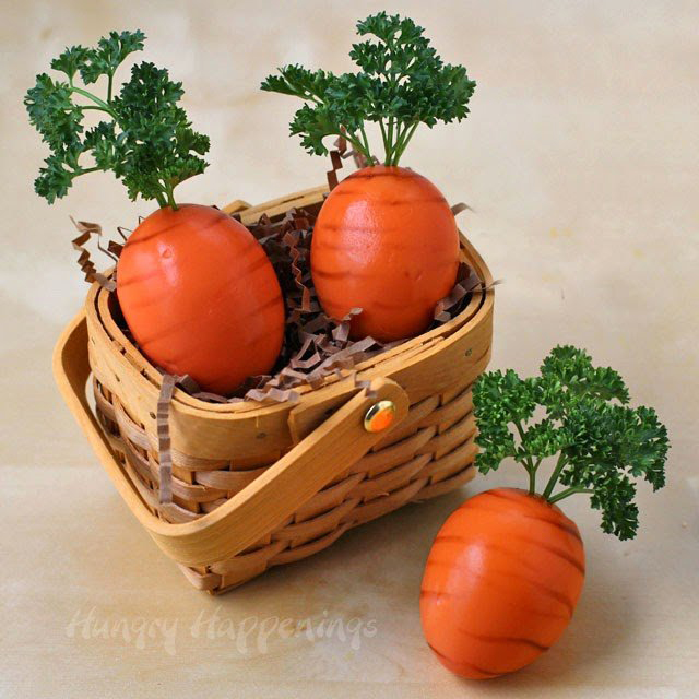 Easter eggs decorated to look like carrots in a basket
