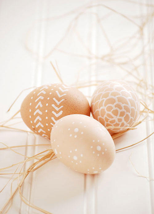 Brown Easter eggs decorated with designs in white paint pen