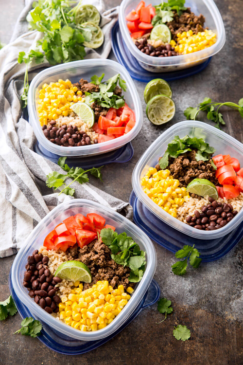 Taco meal prep bowls with taco meat, corn, tomatoes, beans, and rice