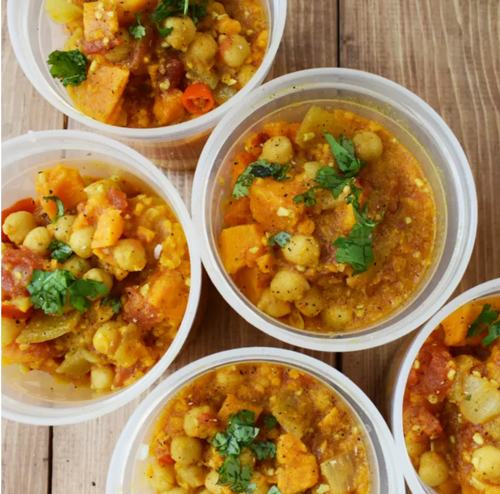 Coconut curry sweet potato stew in plastic bowls