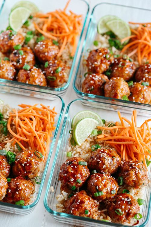 Honey sriracha glazed meatballs with rice and grated carrots