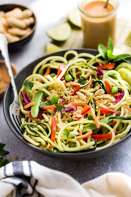 Asian zucchini noodle salad bowl with vegetables