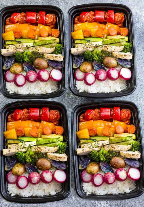 Lemon herb chicken with vegetables and rice divided into meal prep containers