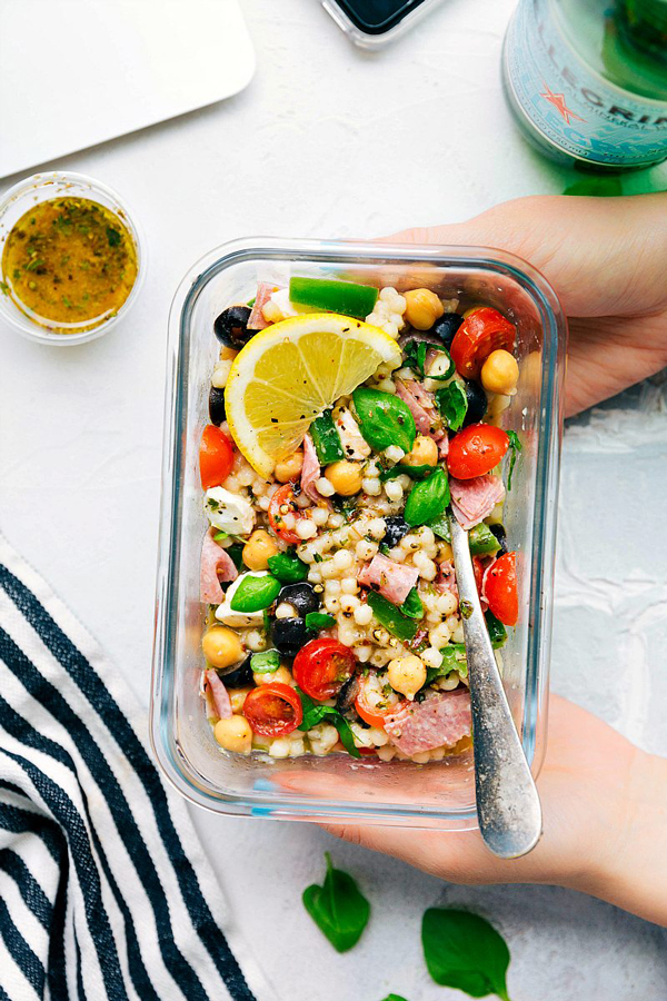 Italian couscous salad in a glass container