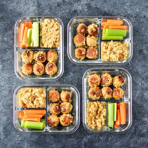 Buffalo chicken meatballs, quinoa, celery and carrot sticks in meal prep containers