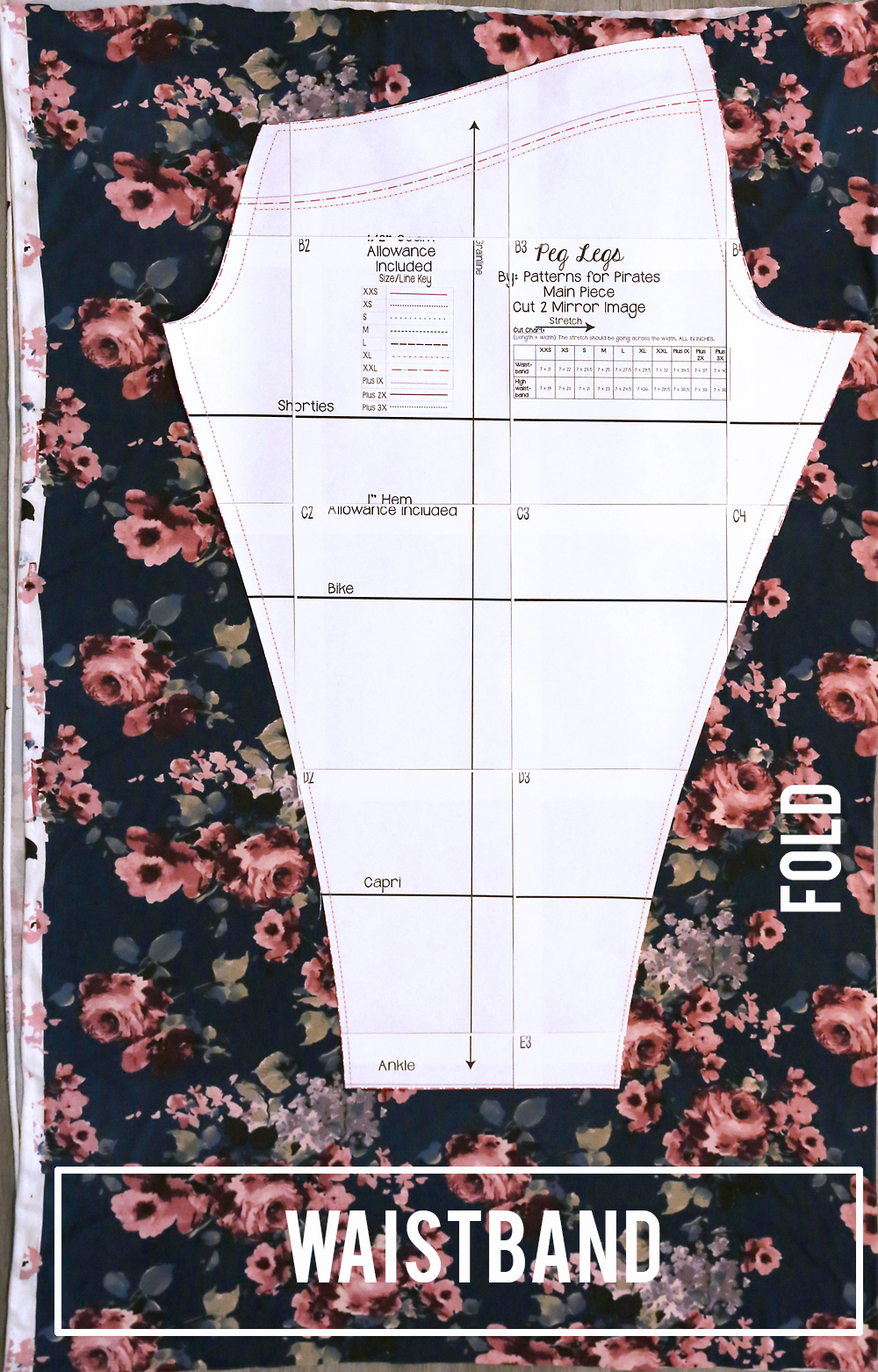 Peg leg sewing pattern laid out on floral knit fabric