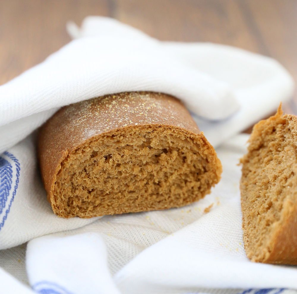 A small loaf of brown bread sliced in half