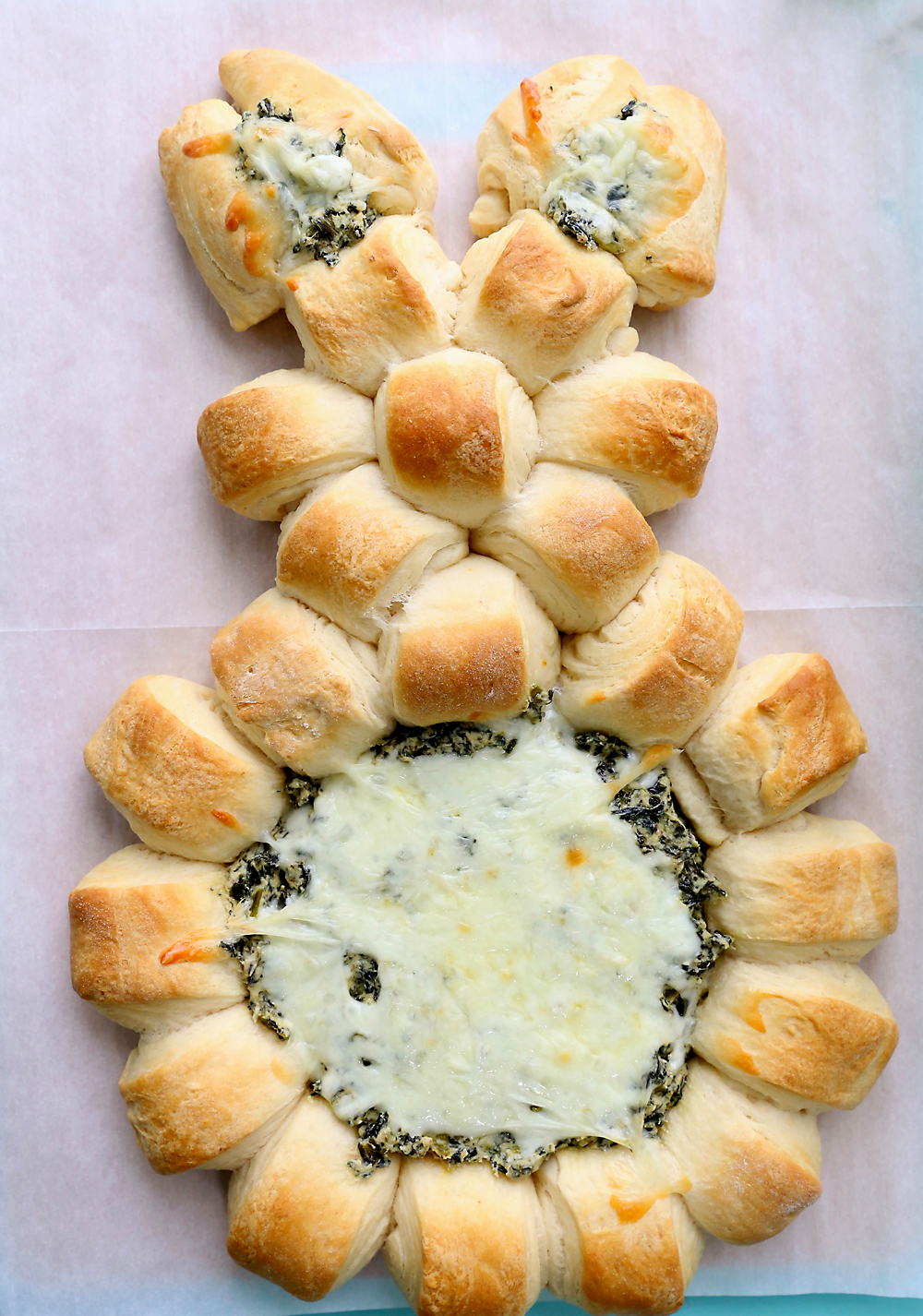 Easter bunny spinach dip appetizer, made with rolls in a bunny shape with spinach dip in the center