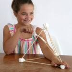 Girl playing with marshmallow catapult