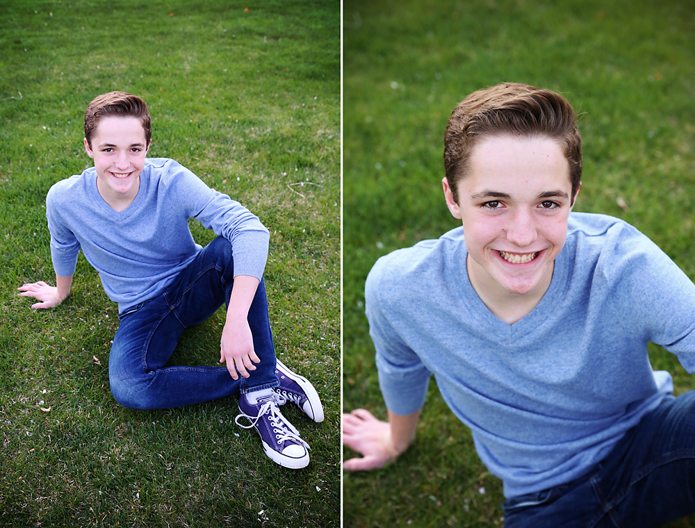 A boy sitting on the grass with one leg crossed over the other, leaning back on one arm