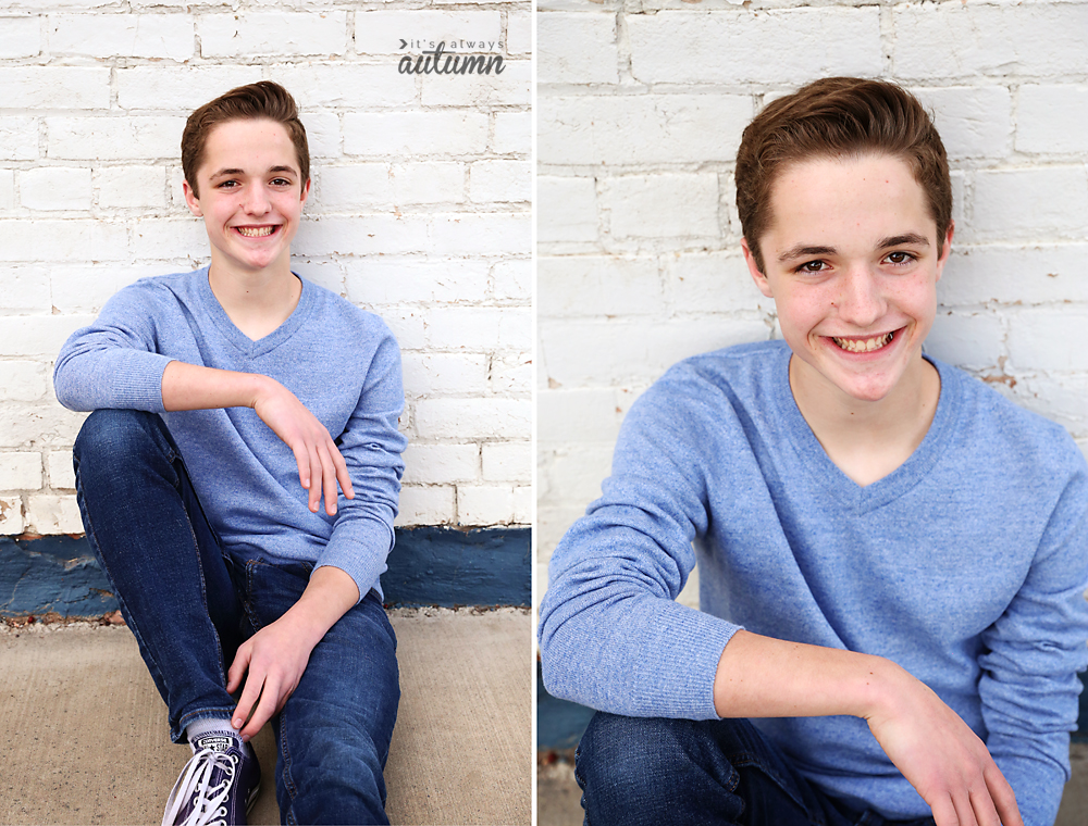 Photo pose for boys: a boy sitting up against a brick wall with one knee up and his arm resting on it