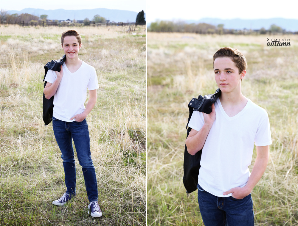 A boy standing with his jacket over his shoulder in a field