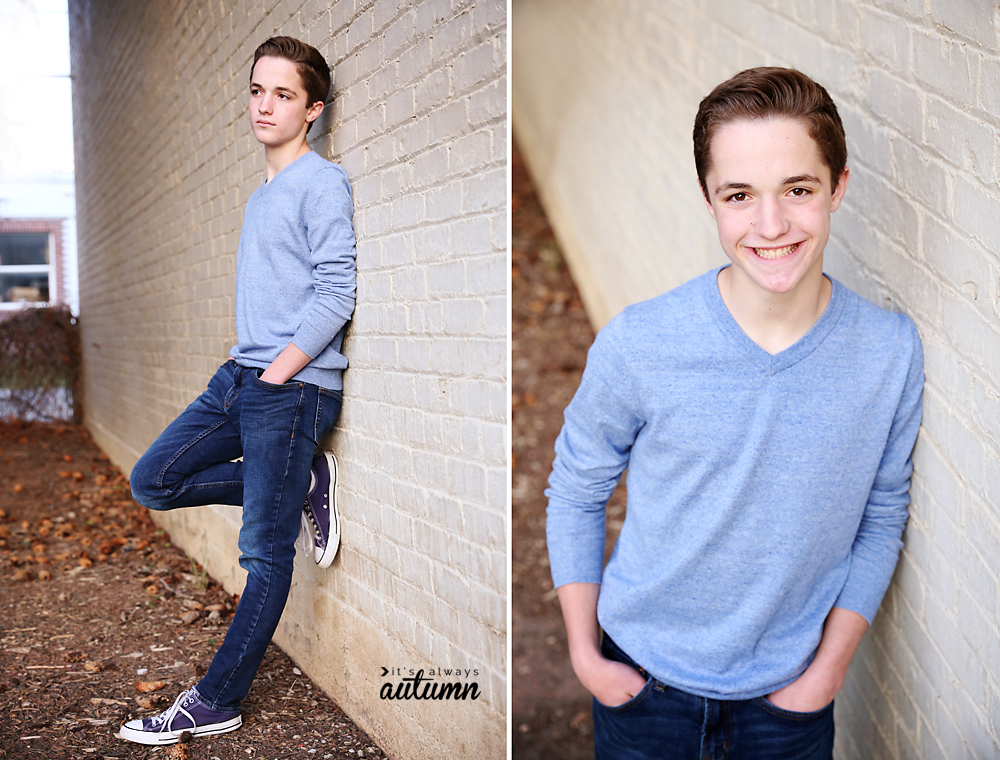 Poses for boys: a boy leaning against a brick wall, looking up at the camera