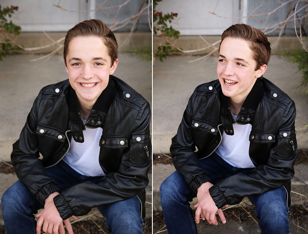 A boy in a leather jacket sitting on the front steps laughing