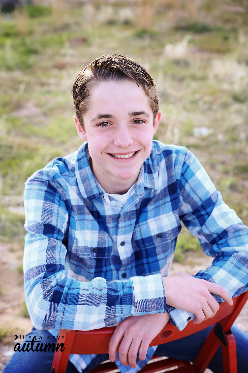 Poses for boys: a boy sitting backwards on a chair