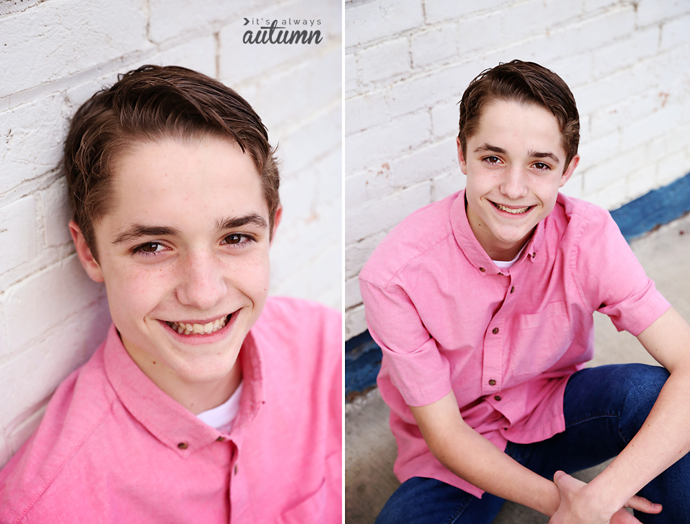 Photo pose for boys: a boy sitting looking up at the camera and smiling