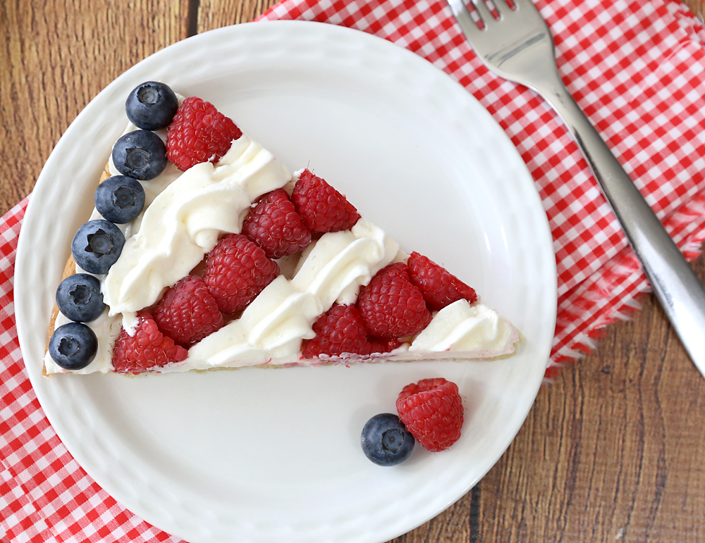 A slice of flag fruit pizza on a plate