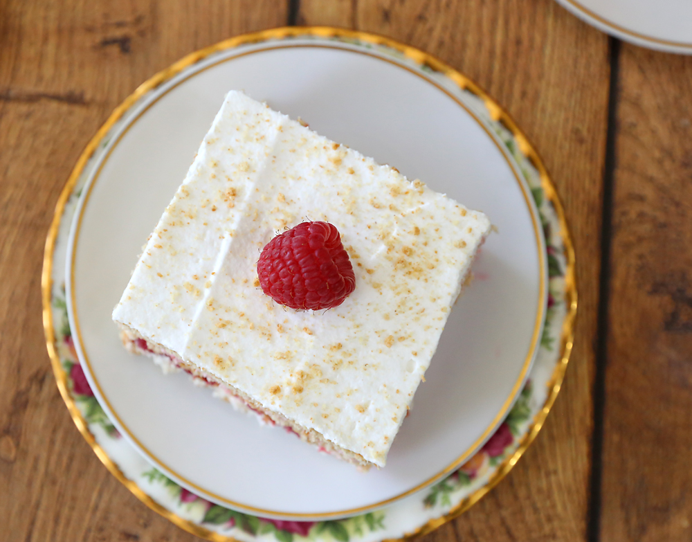 Raspberry cheesecake icebox cake with a raspberry and graham cracker crumbs on top