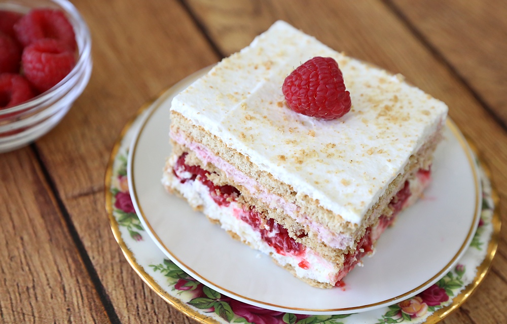 A piece of raspberry cheesecake icebox cake on a plate