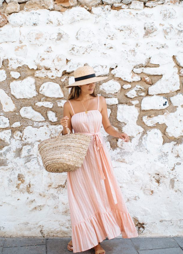 woman wearing long pink dress and hat
