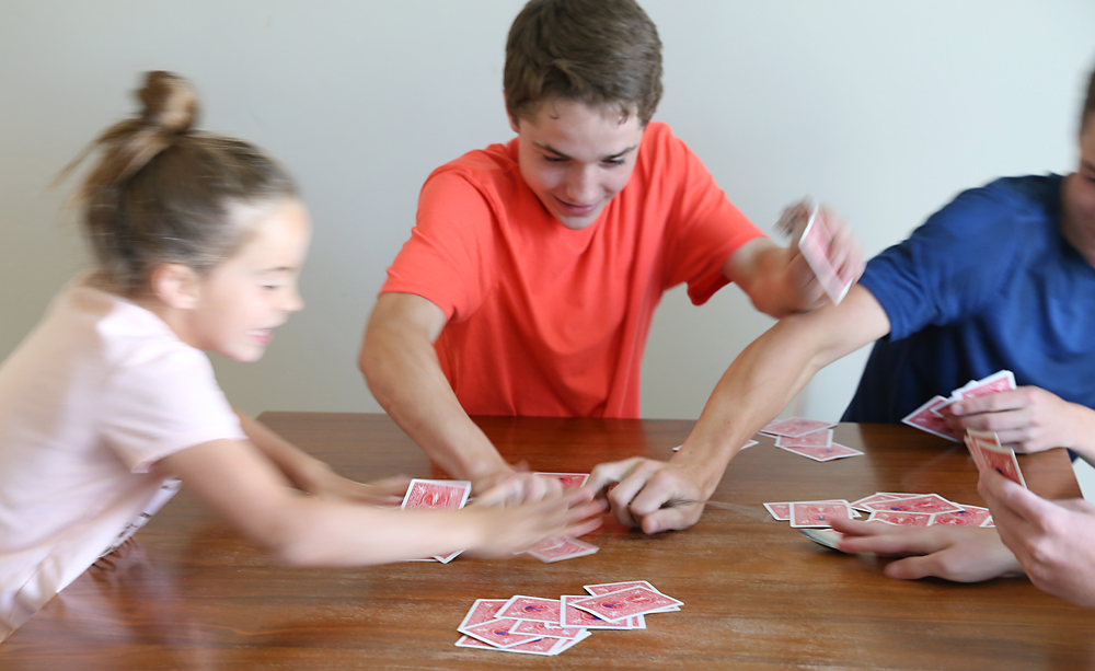 kids having fun playing spoons card game