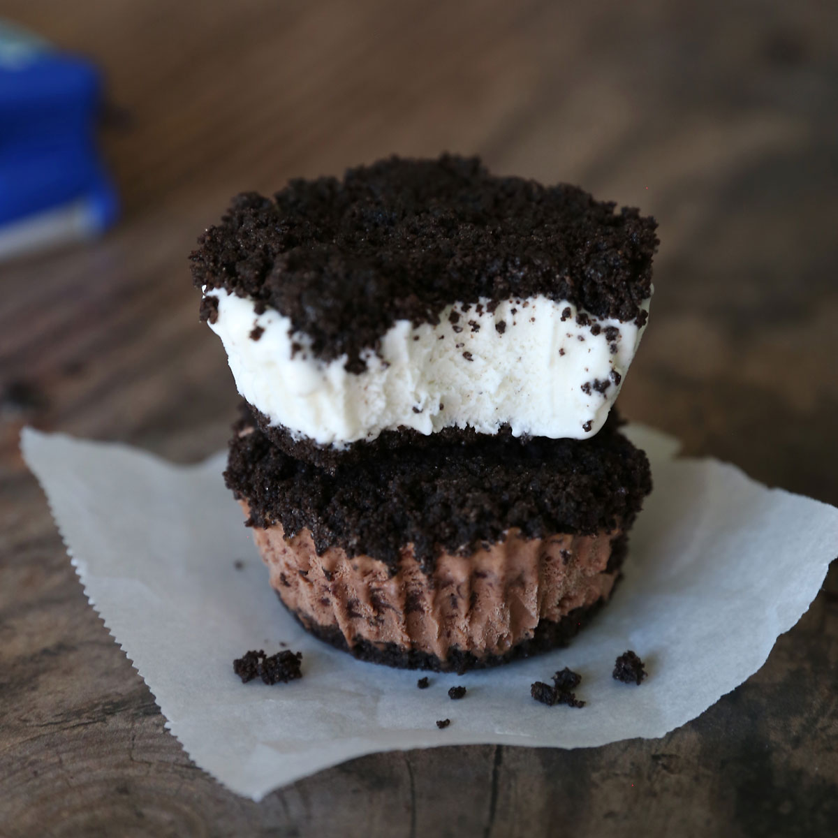 Two Oreo ice cream sandwiches, one with chocolate ice cream and one with vanilla ice cream